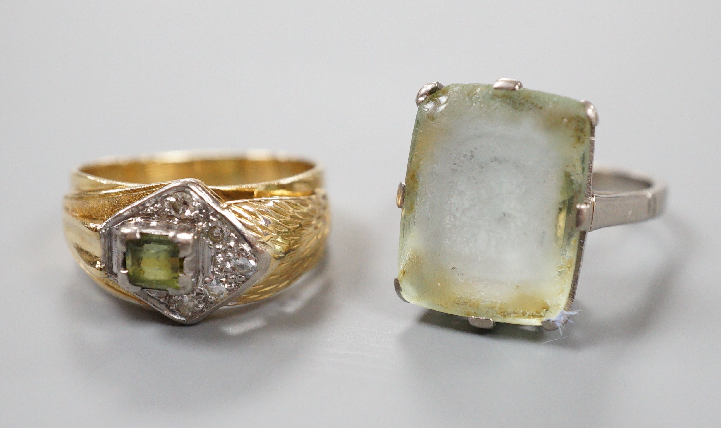 An 18ct white metal and paste set ring, gross 6.1 grams, and one other continental diamond and tourmaline? set cluster ring, stamped 8ct, gross 5.9 grams.